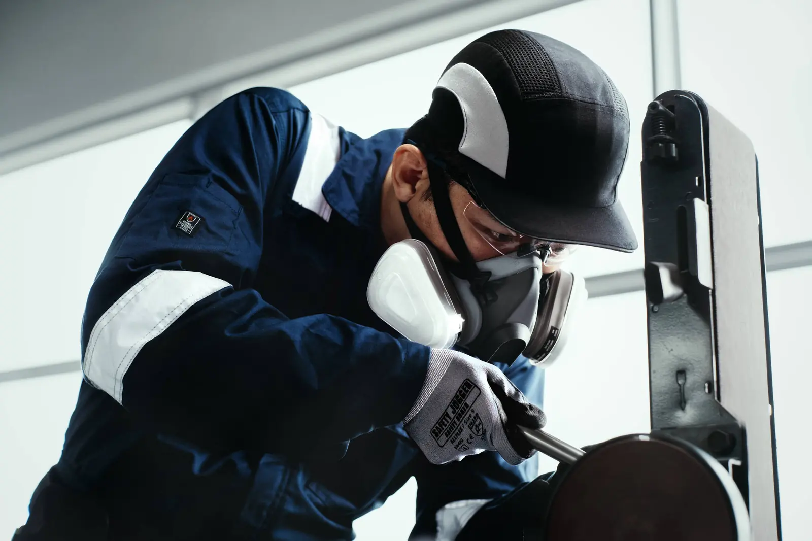 Asian worker wearing catalogue safety eyewear and respiratory protection